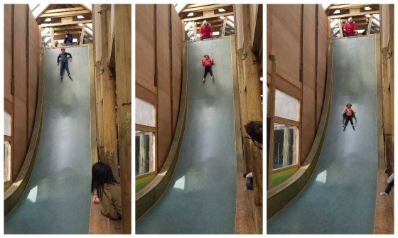The children sliding down the drop slide