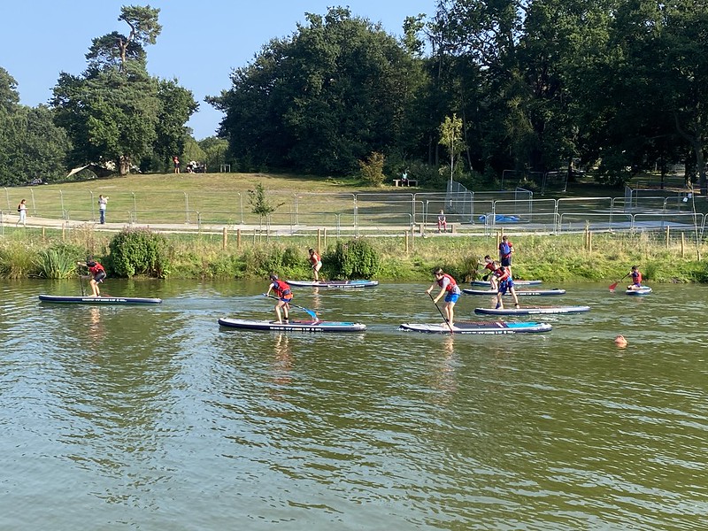 All the partygoers racing on their paddleboards